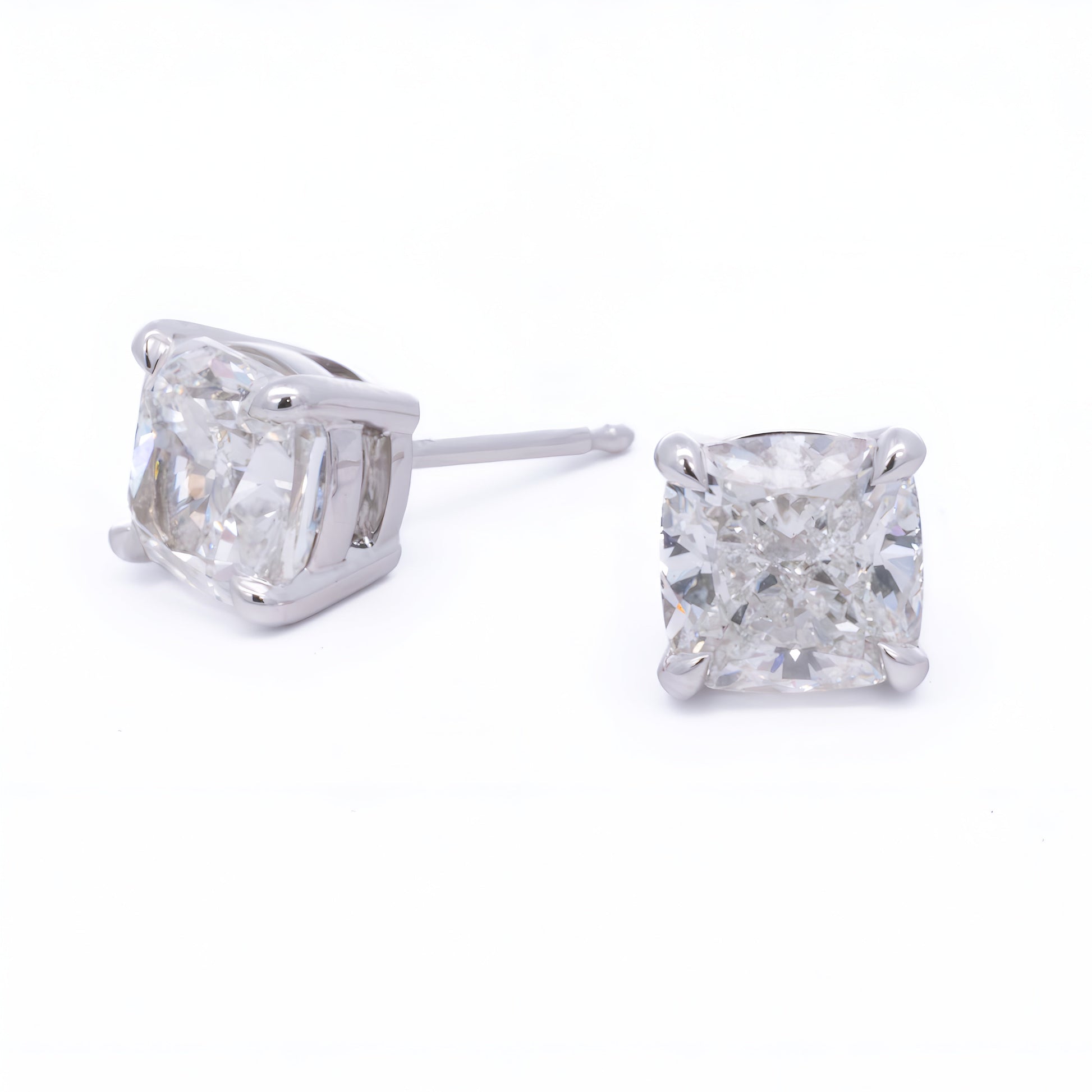 Close-up of a pair of Raffi&Co.® 14K White Gold Round Brilliant Lab Diamond Stud Earrings with large, round gemstones resembling diamonds in a simple prong setting that showcases the sparkling stones prominently.