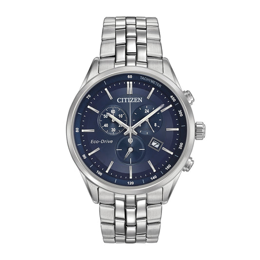 The CITIZEN Corso Eco-Drive 42mm Watch highlights a stylish silver metal link band and features an eye-catching blue dial with three subdials, a date display, and a tachymeter. Its silver case complements the luminescent hands and markers, delivering both elegance and precision.