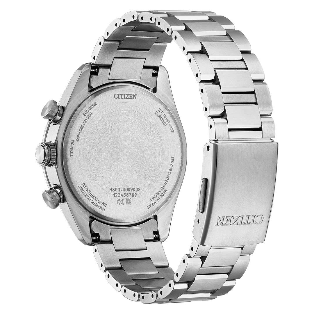 Back view of a CITIZEN Attesa Atomic Time Keeping Super Titanium Eco-Drive 42mm Watch with a silver-tone metal link strap, showcasing the case back with technical inscriptions and a deployment clasp.