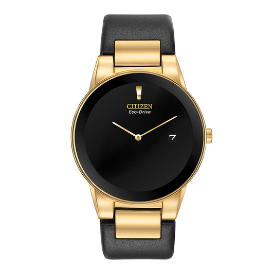 The elegant CITIZEN Axiom Eco-Drive 40mm Watch boasts a black dial, a gold-tone stainless steel case, and a black leather strap. It is equipped with gold hour and minute hands, as well as a small date display.