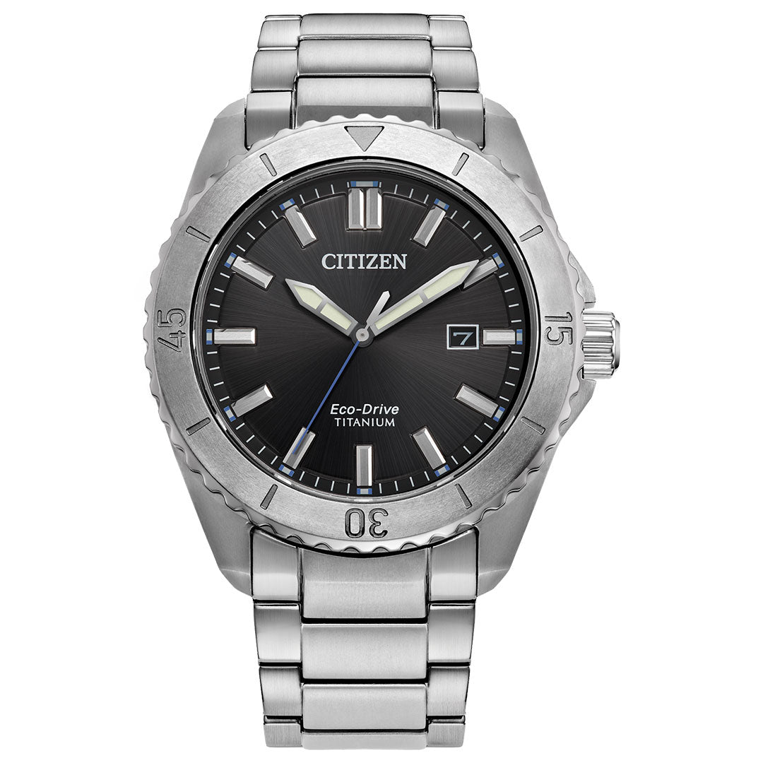 This CITIZEN Brycen Super Titanium Eco-Drive 41mm watch features a dark dial with luminous hands and index markers. It boasts a date window at 3 o'clock and is crafted in durable Super Titanium, complemented by a robust brushed metal bracelet.