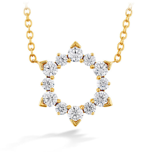 The Hearts On Fire Aerial Eclipse Necklace features a pendant adorned with symmetrically arranged round diamonds in a sunburst design. Crafted in 18 karat yellow gold, the pendant elegantly hangs from a delicate chain.