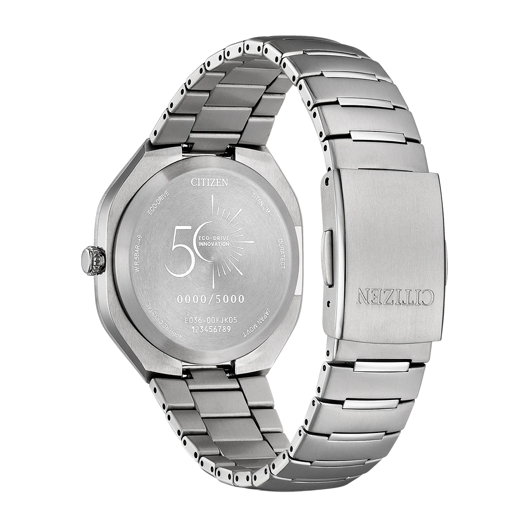 A CITIZEN Photon Eco-Drive 39.6mm Watch Limited Edition of 5,000 Pieces is shown from the back, featuring an engraved case with “CITIZEN,” serial numbers, and a special 50th-anniversary logo. The stainless steel bracelet and clasp are also visible, emphasizing the sport-luxury design of this CITIZEN Eco-Drive timepiece.