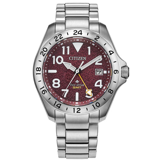 The CITIZEN Promaster Land GMT Eco-Drive 39.5mm Watch features a silver case, metallic bracelet, red textured dial with white numerals, date at 3 o’clock, 24-hour bezel, and yellow GMT hand for travel-ready functionality.