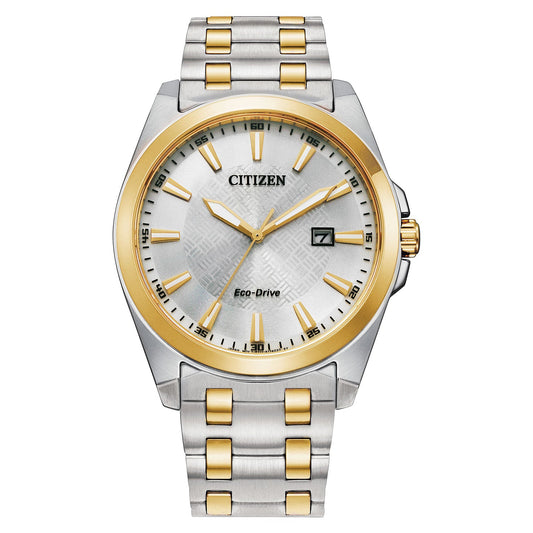 A CITIZEN Peyten Eco-Drive 41mm Watch with a round face features a silver dial adorned with gold hour markers and hands, along with a date window positioned at 3 o'clock. The bracelet showcases alternating silver and gold links.