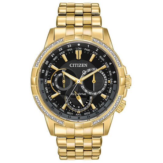 The CITIZEN Calendrier Eco-Drive 44mm Watch boasts a striking gold-tone stainless steel design, featuring a black dial adorned with multiple subdials for displaying date and time across different zones. Its bezel is elegantly embellished with small crystals, all driven by Eco-Drive technology, and complemented by a coordinating gold link bracelet.