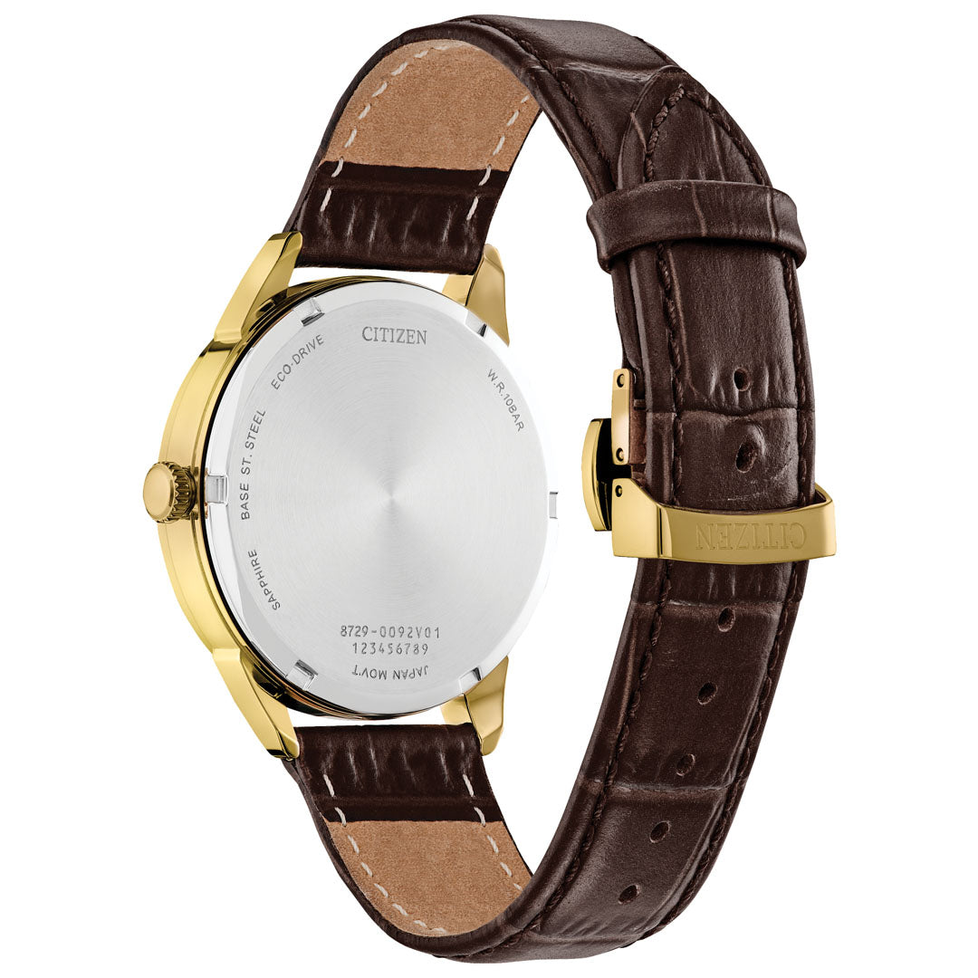 A rear view of the elegant Citizen Rolan Eco-Drive 40mm watch showcases its gold-tone case and brown leather strap. The stainless steel back displays specifications such as water resistance and model numbers, while the clasp is engraved with "Citizen.