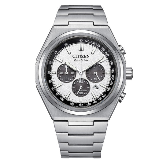 The CITIZEN Forza Chrono Super Titanium Eco-Drive 42.5mm Watch is a silver Citizen timepiece featuring a stainless steel band and innovative Eco-Drive technology. This chronograph watch includes a round dial with a white face, black subdials, and a tachymeter scale. Its crown and two pushers are conveniently positioned on the right side.