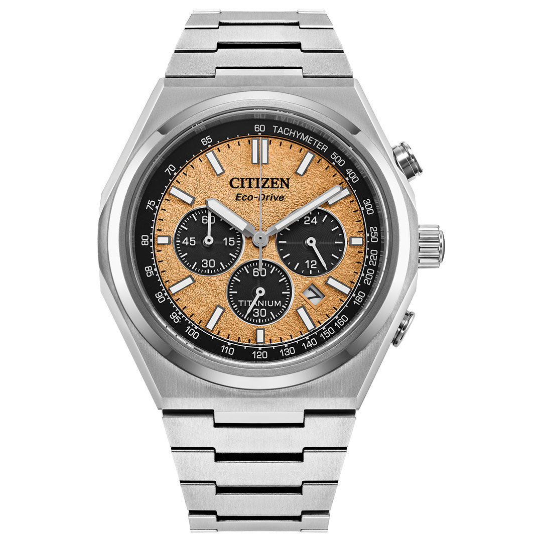 This CITIZEN Forza Chrono Super Titanium Eco-Drive 42.5mm Watch, crafted with Super Titanium™ technology, showcases a silver metal band and a round face. Its beige patterned dial is adorned with three black chronograph dials, a tachymeter scale, and sleek silver hour markers. The brand name CITIZEN is elegantly displayed at the top.