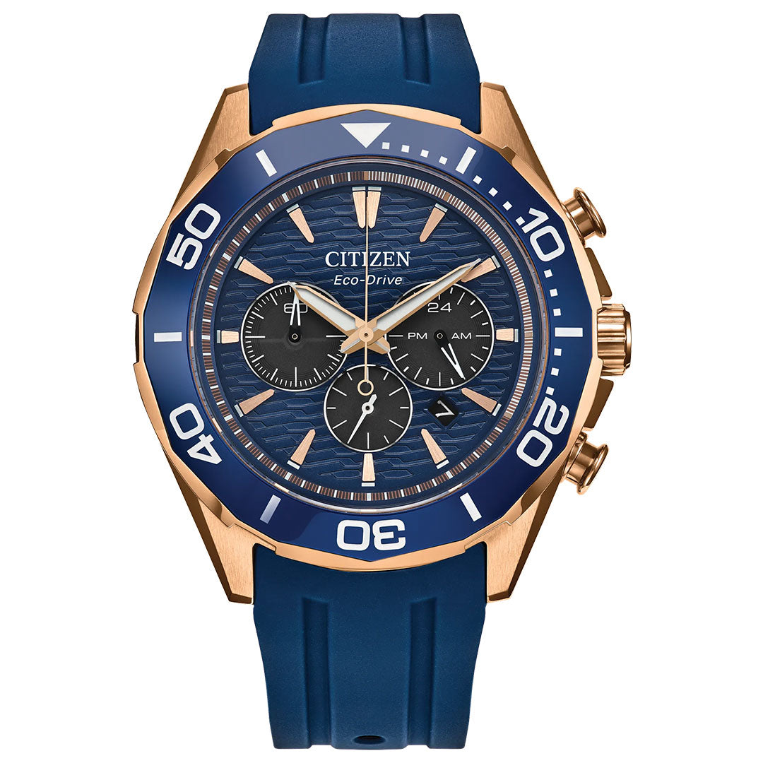 The CITIZEN Endeavor Chrono Eco-Drive 43mm Watch features a blue face, blue bezel, and blue silicone strap. Its gold-tone case includes three subdials and gold hour markers, showcasing nautical chronograph style with white bezel numerals.
