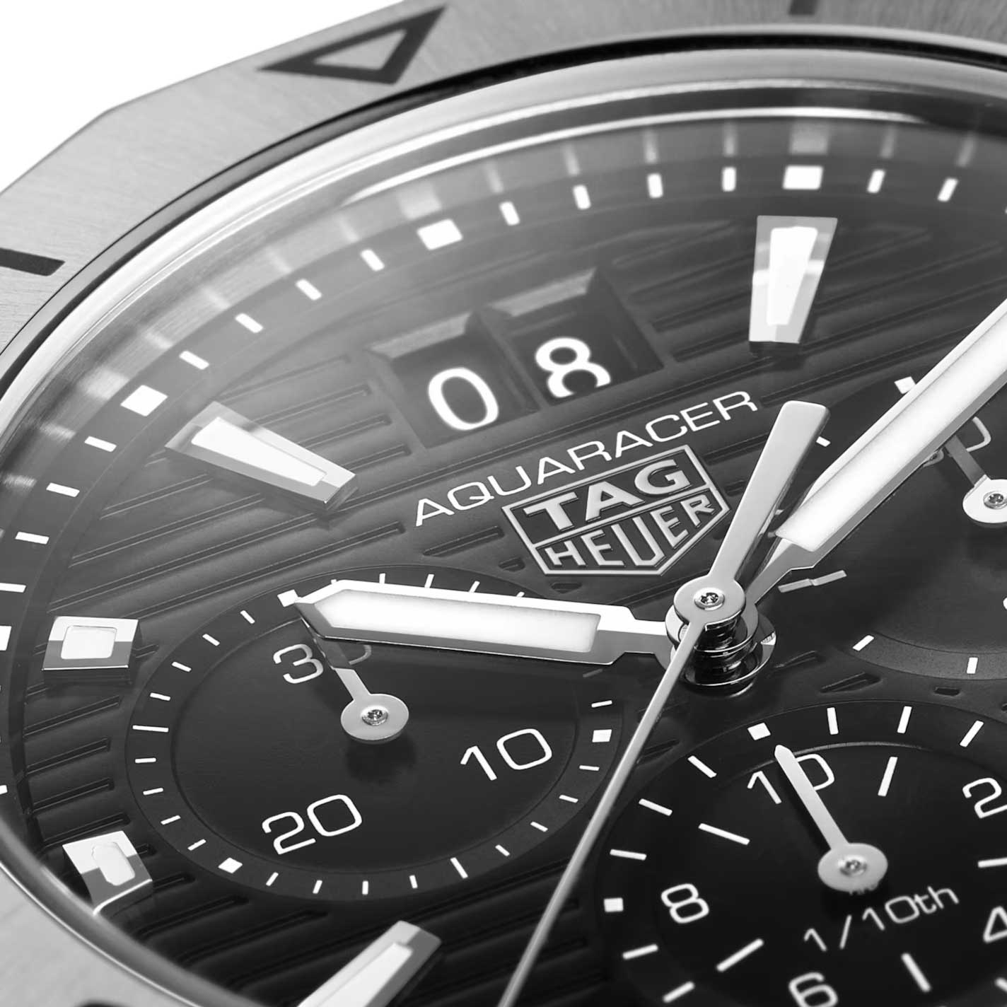 Close-up of the TAG Heuer Aquaracer Professional 200 Chronograph Quartz 40mm watch face, featuring chronograph subdials, luminous hands and markers, and a date window. The TAG Heuer branding and intricate textures stand out, highlighted by the durable steel case and notable water resistance.