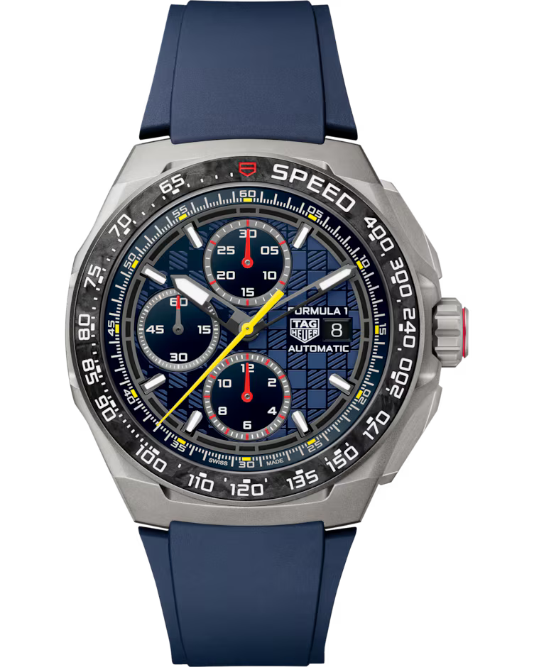 The TAG Heuer Formula 1 Chronograph x Oracle Red Bull Racing Special Edition Automatic 44mm watch features a silver case, blue rubber strap, stopwatch function, three blue subdials, a yellow second hand, and a checkered pattern on the dial. The bezel is marked with speed indicators.