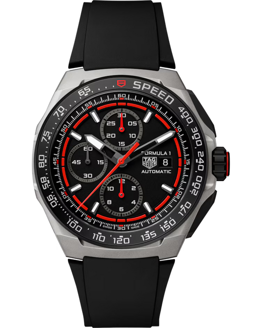 The TAG Heuer Formula 1 Chronograph Automatic 44mm Watch by TAG Heuer features a black dial with three subdials, a date window, red accents, and a black rubber strap. Its bezel is marked “SPEED” and includes a tachymeter scale.