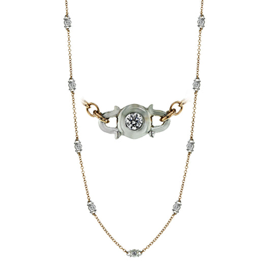 The Simon G. 18K Yellow Gold Diamond Station Necklace by Simon G features a timeless design with a central silver pendant accented by a circular pattern and centered diamond. The gold chain is embellished with evenly spaced small white diamonds along its length.