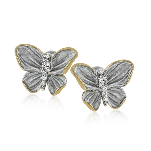 A pair of luxurious Simon G 18K White and Yellow Gold Diamond Earrings, featuring intricately crafted butterfly shapes with silver-toned wings and dazzling diamond-adorned bodies, set against a plain white background.
