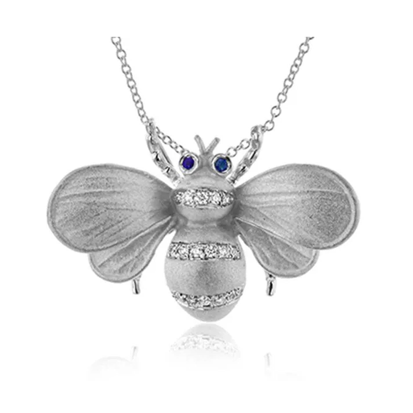 The Simon G. Monarch Bee 18K Yellow Gold Diamond Necklace Pendant boasts textured silver wings and striking blue gemstone eyes, with its body embellished with 0.12 ctw diamonds, gracefully suspended on a delicate chain.