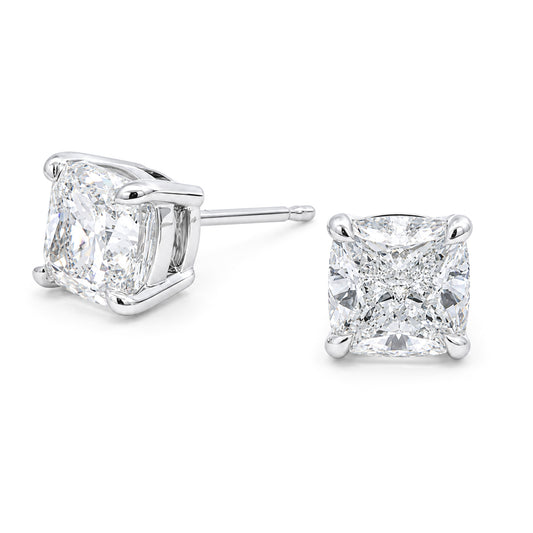 The Raffi&Co.® 14K White Gold Cushion Lab Diamond Stud Earrings feature a pair of VS1 clarity lab-grown diamonds set in elegant prong settings, beautifully displayed against a white background.