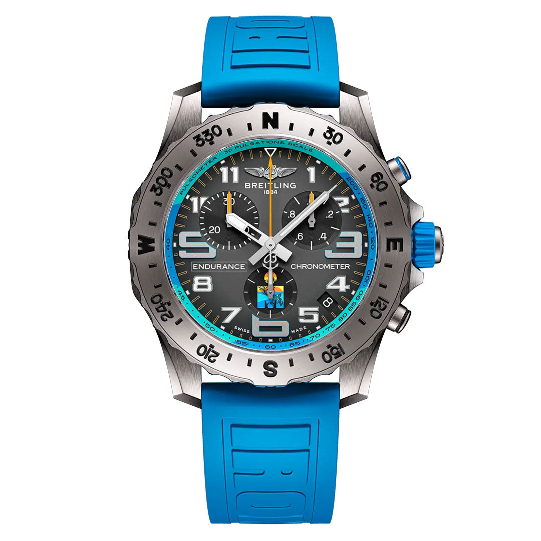 The BREITLING Professional Endurance Pro World Championship 2025 features a black dial, silver hands, white numerals, turquoise accents, and a bright blue rubber strap, with compass bezel and chronograph on the face.