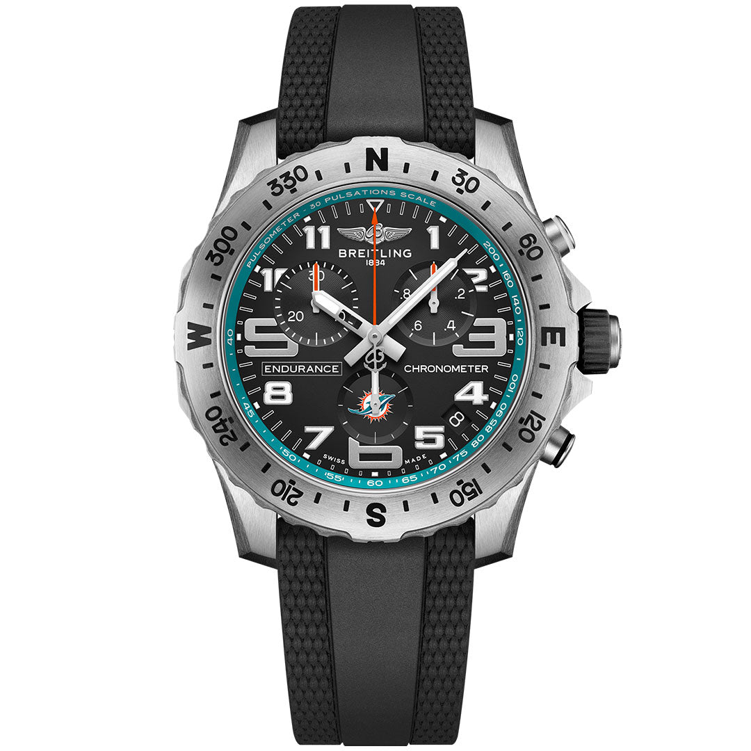 The Breitling Endurance Pro 44 NFL edition features a black rubber strap, black dial, silver bezel with black numerals, three subdials, white and turquoise accents, and bold white numerals at 12, 3, 6, and 9.