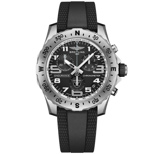 The Breitling Endurance Pro 44 is a silver and black watch with a black dial, white Arabic numerals, rotating bezel, textured black rubber strap, multiple dials, and the iconic Breitling logo.