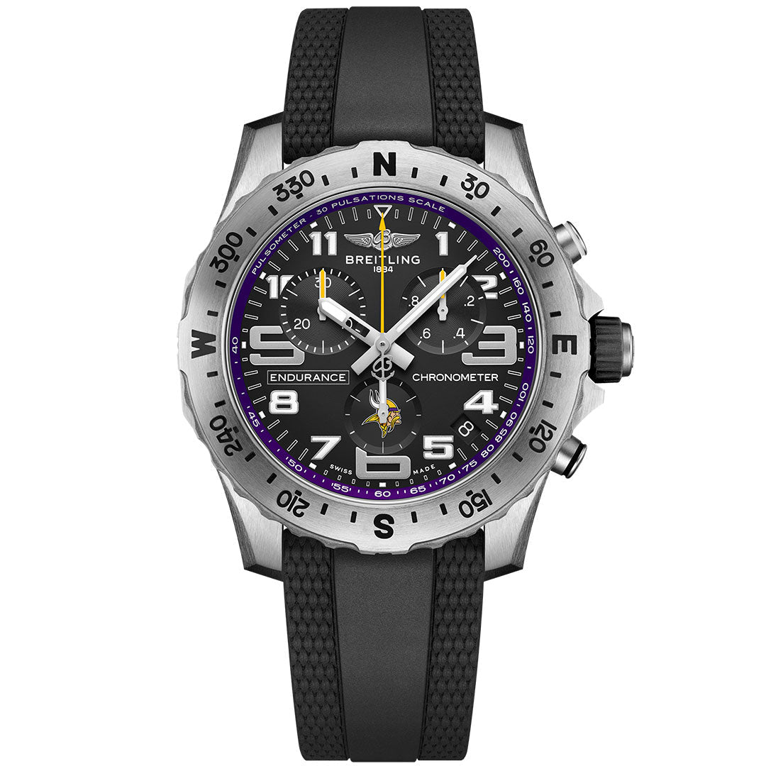 The BREITLING Endurance Pro 44 features a black strap, black dial with white numerals, luminous hands, purple accents like the Minnesota Vikings watch, a silver compass bezel, and multiple subdials.