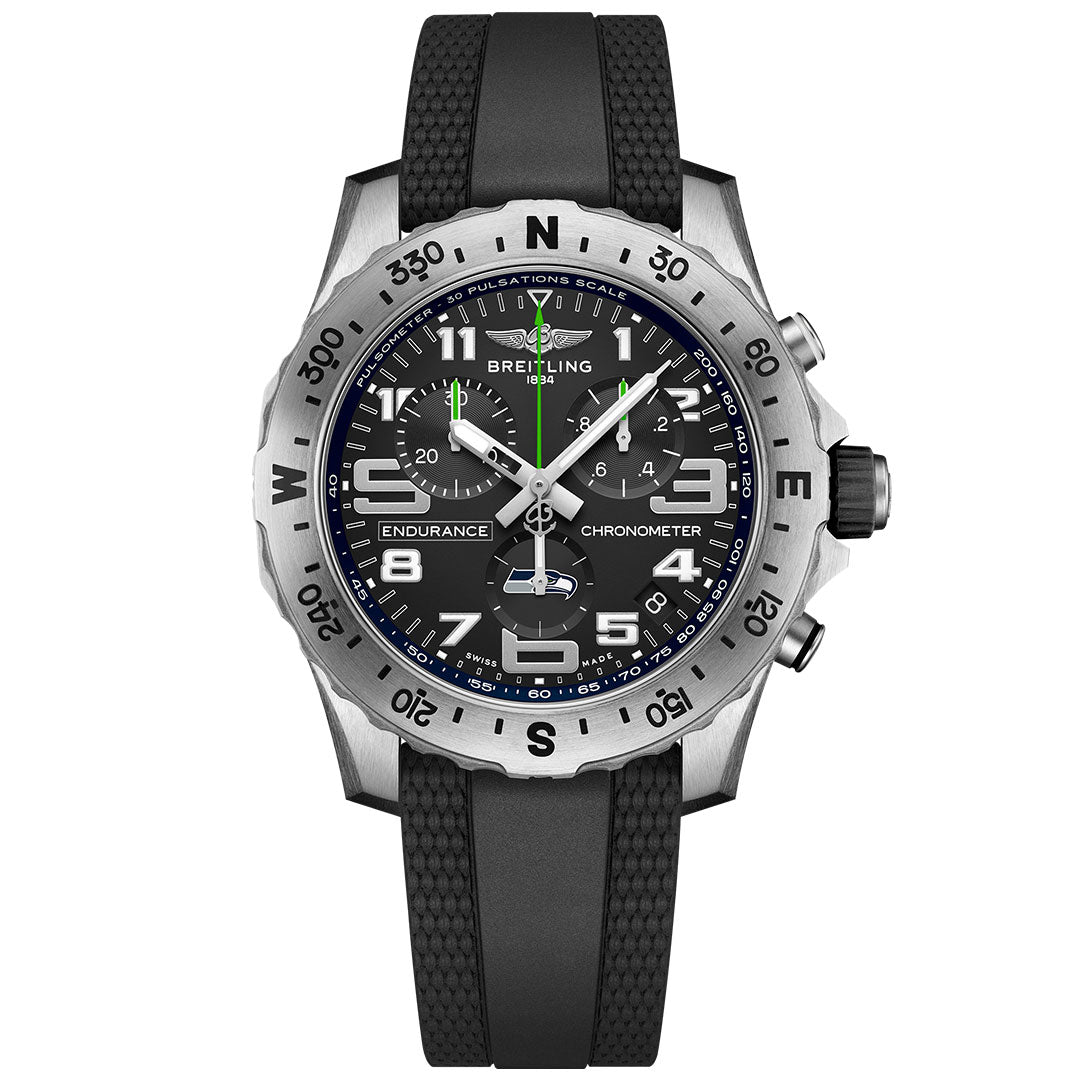 The BREITLING Endurance Pro 44 by Breitling features a black rubber strap, black dial with white markers, silver bezel with compass points, luminous hands, subdials, and date window—ideal for Seattle Seahawks watch fans.