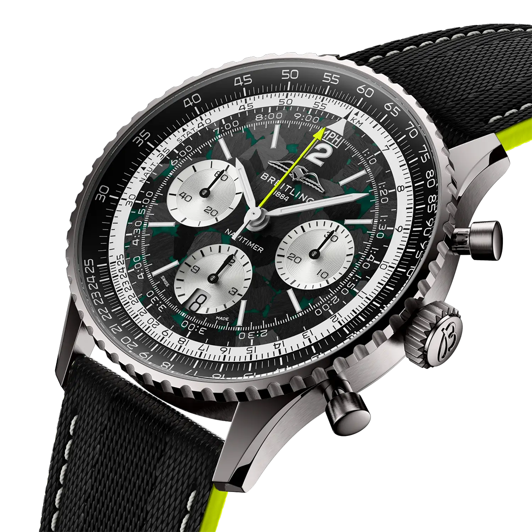 BREITLING Navitimer B01 Chronograph 43 Aston Martin Aramco Formula One Team Edition with a black and green patterned dial, three silver sub-dials, a rotating slide rule bezel, and a black strap with neon green edges.
