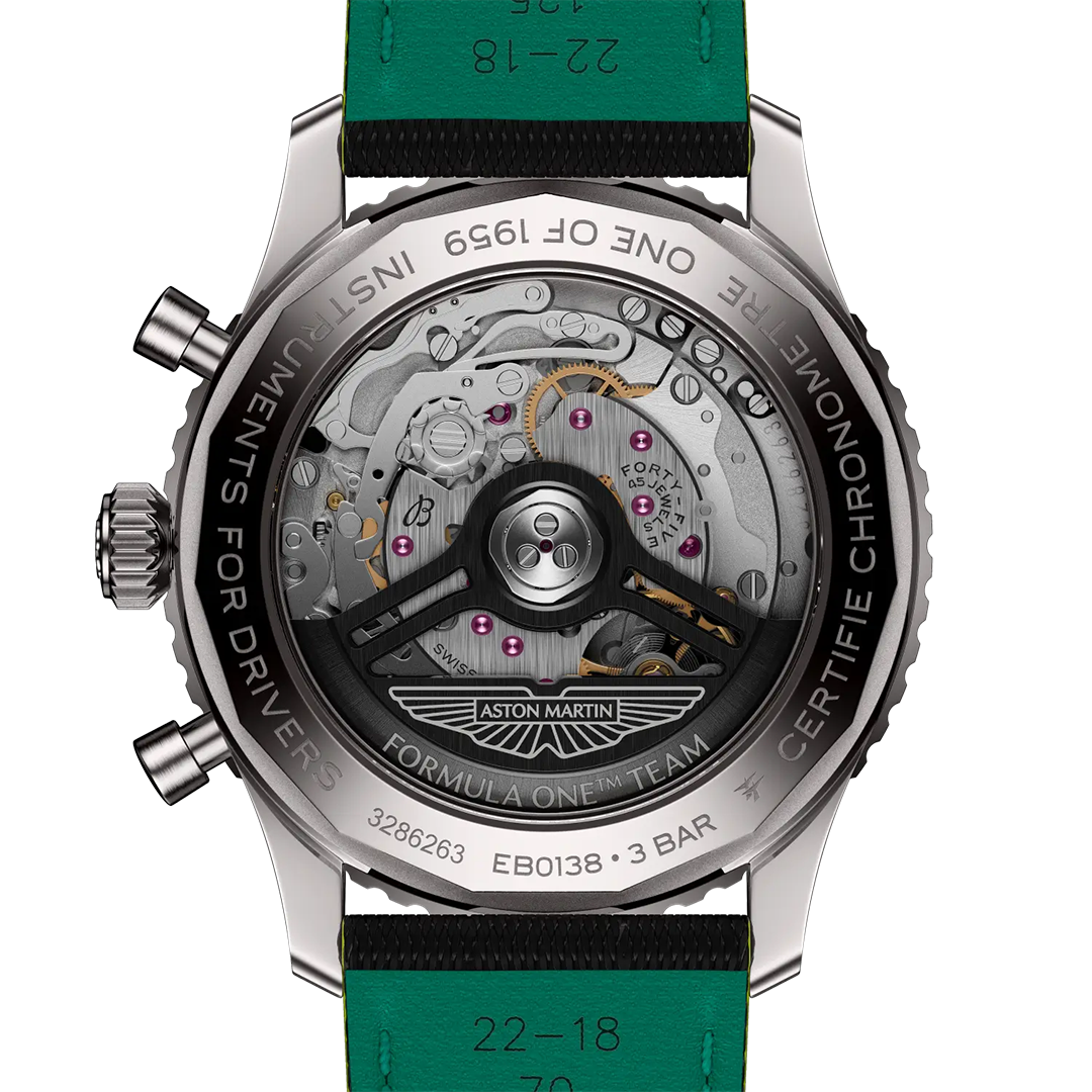 The exhibition case back of a BREITLING Navitimer B01 Chronograph 43 Aston Martin Aramco Formula One Team Edition, showing the mechanical movement and an Aston Martin Formula One Team logo on the rotor.