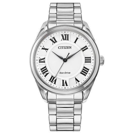 Introducing the CITIZEN Fiore Eco-Drive 35mm Watch, a stylish ladies timepiece by CITIZEN. This sophisticated watch showcases Eco-Drive technology and features a stainless steel bracelet paired with a round white dial. Black Roman numerals and two sleek black hands embellish the silver watch face, with the CITIZEN brand name proudly displayed at the top of the dial.