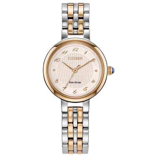 The CITIZEN L Classic Eco-Drive 27.7mm women's watch features a round gold-tone face with gold numerals, a blue-accented crown, a textured dial, and a two-tone gold and silver link bracelet for added elegance.