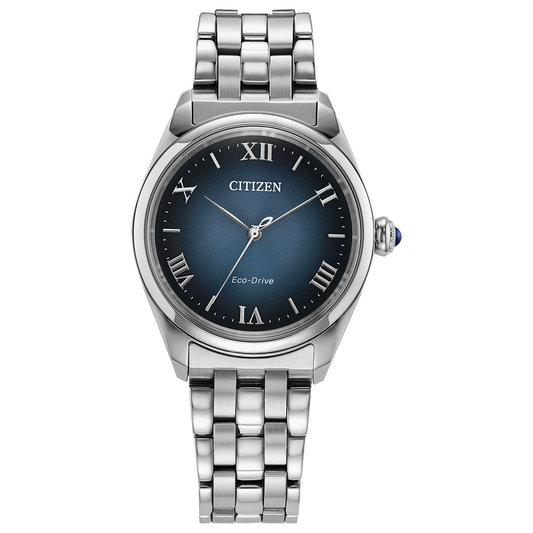 The CITIZEN Classic L Eco-Drive 33mm women's watch features a silver stainless steel case, blue gradient dial with silver Roman numerals, and Eco-Drive technology. The dial displays "CITIZEN" and "Eco-Drive.