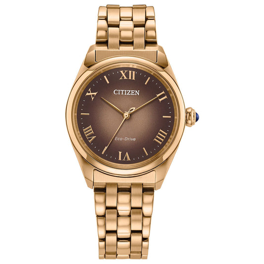 The CITIZEN L Classic Eco-Drive 33mm Watch features a gold round case, brown dial, gold Roman numeral markers, three hands, and a gold link band.