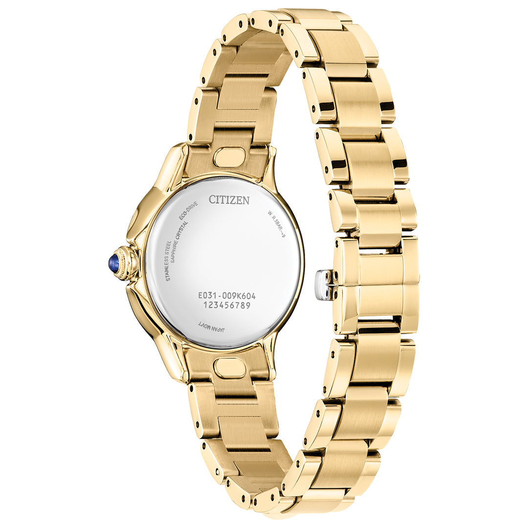 The CITIZEN Le L Ceci Eco-Drive 31.5mm Watch features a gold-tone stainless steel band, smooth round case back, and a blue gemstone crown detail. It uses Eco-Drive technology for reliability and has model info engraved on the back.