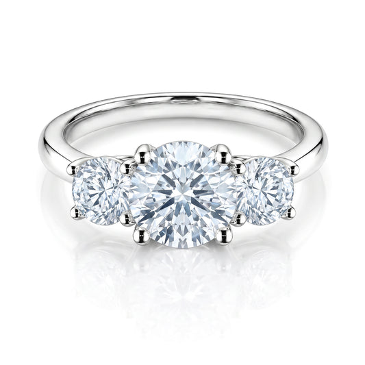 The Raffi&Co.® Signature 14K White Gold Round Brilliant Three Stone Diamond Engagement Ring features a striking round center diamond accented by two smaller rounds on a polished white gold band.