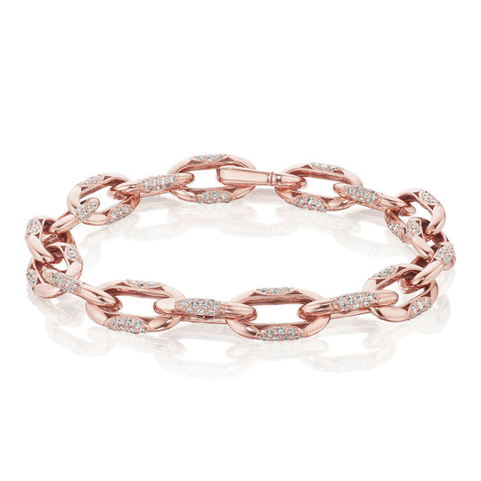 The Tacori Crescent Eclipse 18K Rose Gold Small Link Diamond Bracelet, a creation by Tacori, is adorned with small, sparkling round-brilliant diamonds on each link. It showcases exquisite artisanry and is elegantly displayed against a white reflective surface.