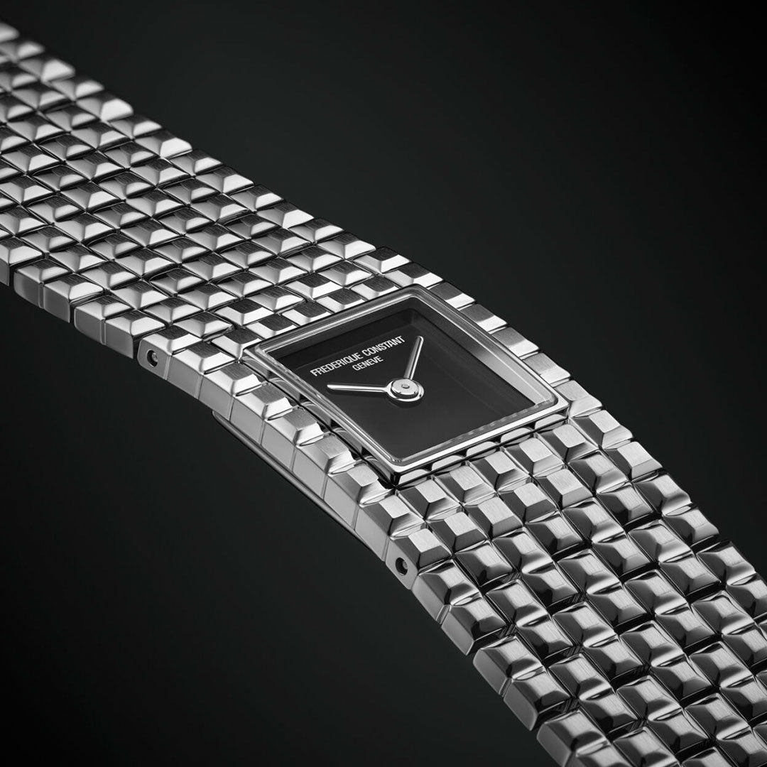 A close-up of the Frederique Constant Classics Manchette Quartz 25.7mm watch, featuring a square black dial with silver hands and a Clou de Paris textured silver bracelet. The Frederique Constant brand name is visible on the dial.