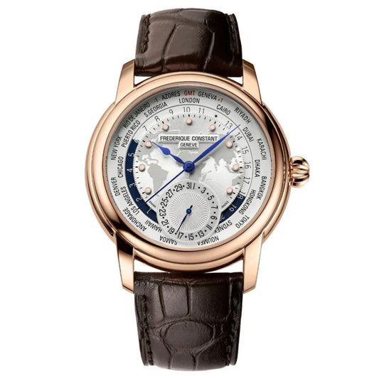 The Frederique Constant Manufacture Classic Worldtimer Automatic 42mm Watch exudes luxury with its brown leather strap and intricately detailed silver dial displaying city names for different time zones. It is equipped with day and date indicators, elegant hands, and is elegantly framed by a gold-toned bezel.