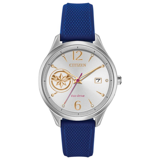 The CITIZEN Marvel Captain Marvel Eco-Drive 37mm Watch showcases a sleek silver case and a white dial adorned with gold hour markers, including the numbers 12 and 6. It features a blue strap and incorporates a subtle compass motif on the left side. Equipped with Eco-Drive technology, it also includes a discreet date window positioned at 3 o'clock.