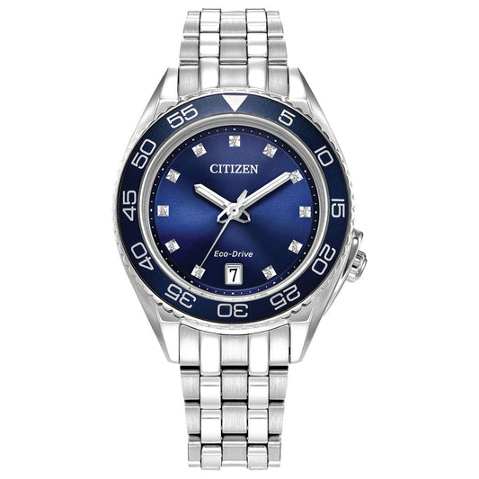 The CITIZEN Carson Eco-Drive 35mm Watch features a silver-tone stainless steel case with a blue dial, adorned with silver hour markers and a date display positioned at 3 o'clock. Its bezel is enhanced by white numerals and comes paired with a metal link bracelet.