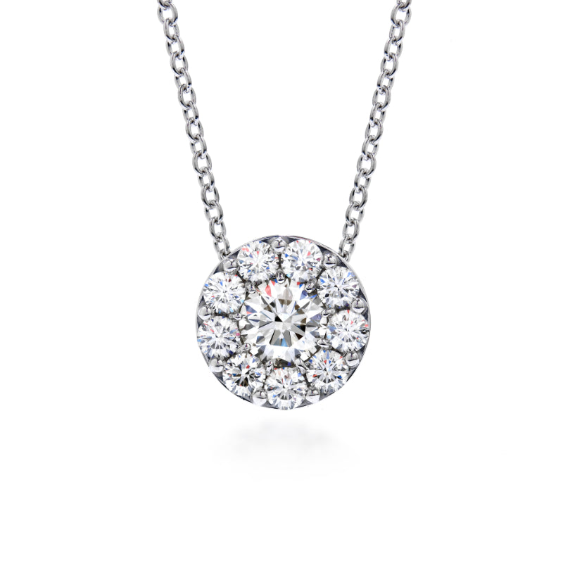The Hearts On Fire Fulfillment Pendant Necklace features a silver necklace with a stunning round pendant adorned with dazzling diamonds, serving as an elegant focal point. The 18 Karat White Gold Pendant beautifully complements the thin chain for a refined look.