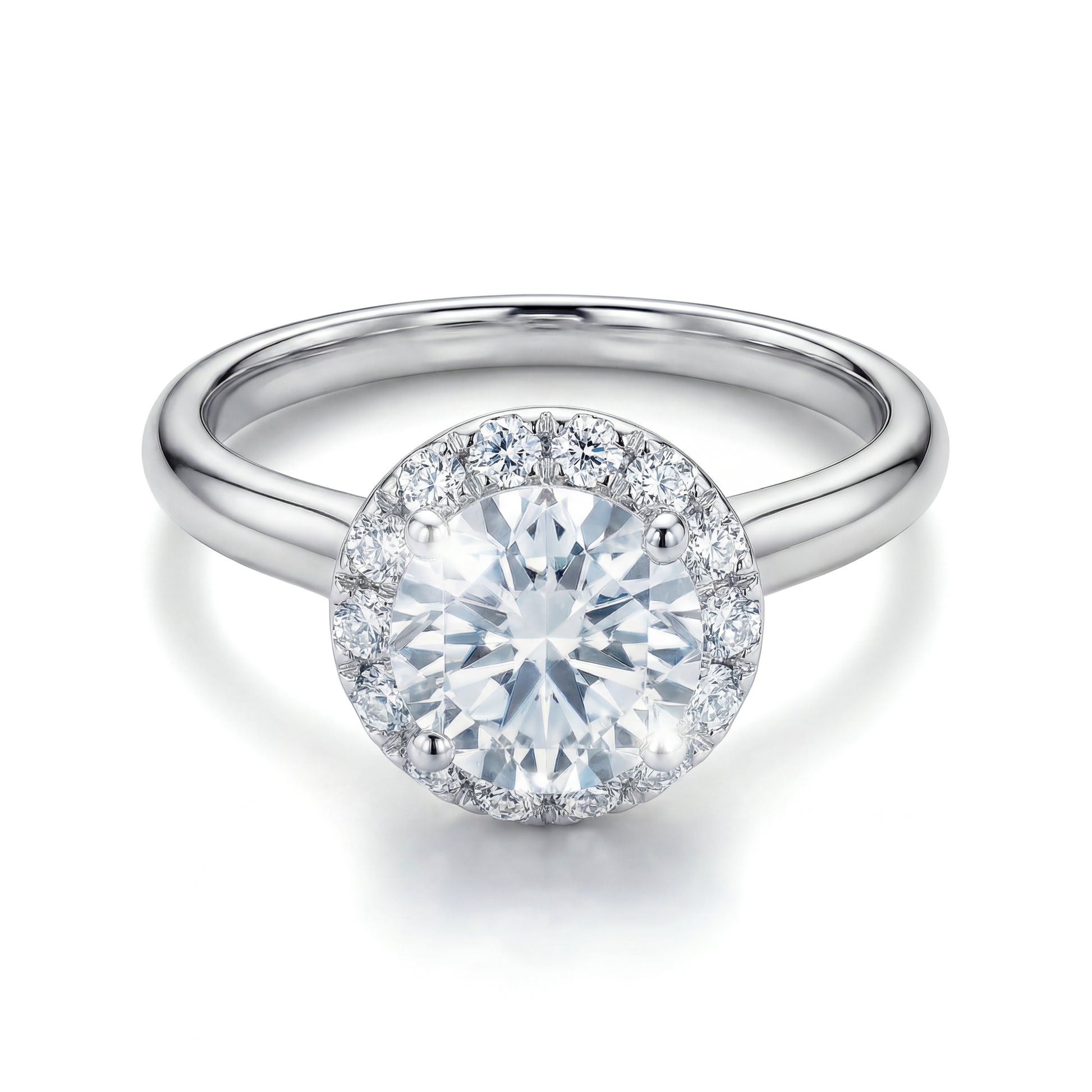The Raffi&Co.® 14K White Gold Round Brilliant Diamond Halo Engagement Ring features a round brilliant diamond with a sparkling halo on a polished band, shown against a white background.