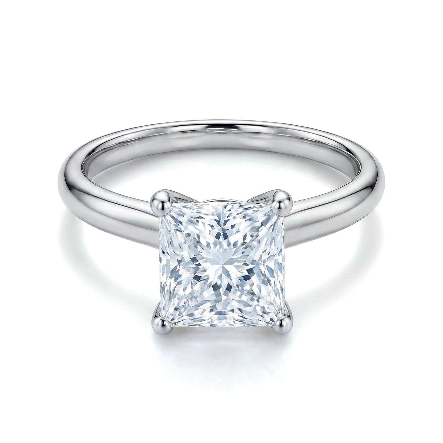 The Raffi&Co.® 18K White Gold Princess Solitaire Diamond Engagement Ring showcases a GIA certified princess cut diamond in a four-prong setting, elegantly presented against a white backdrop.