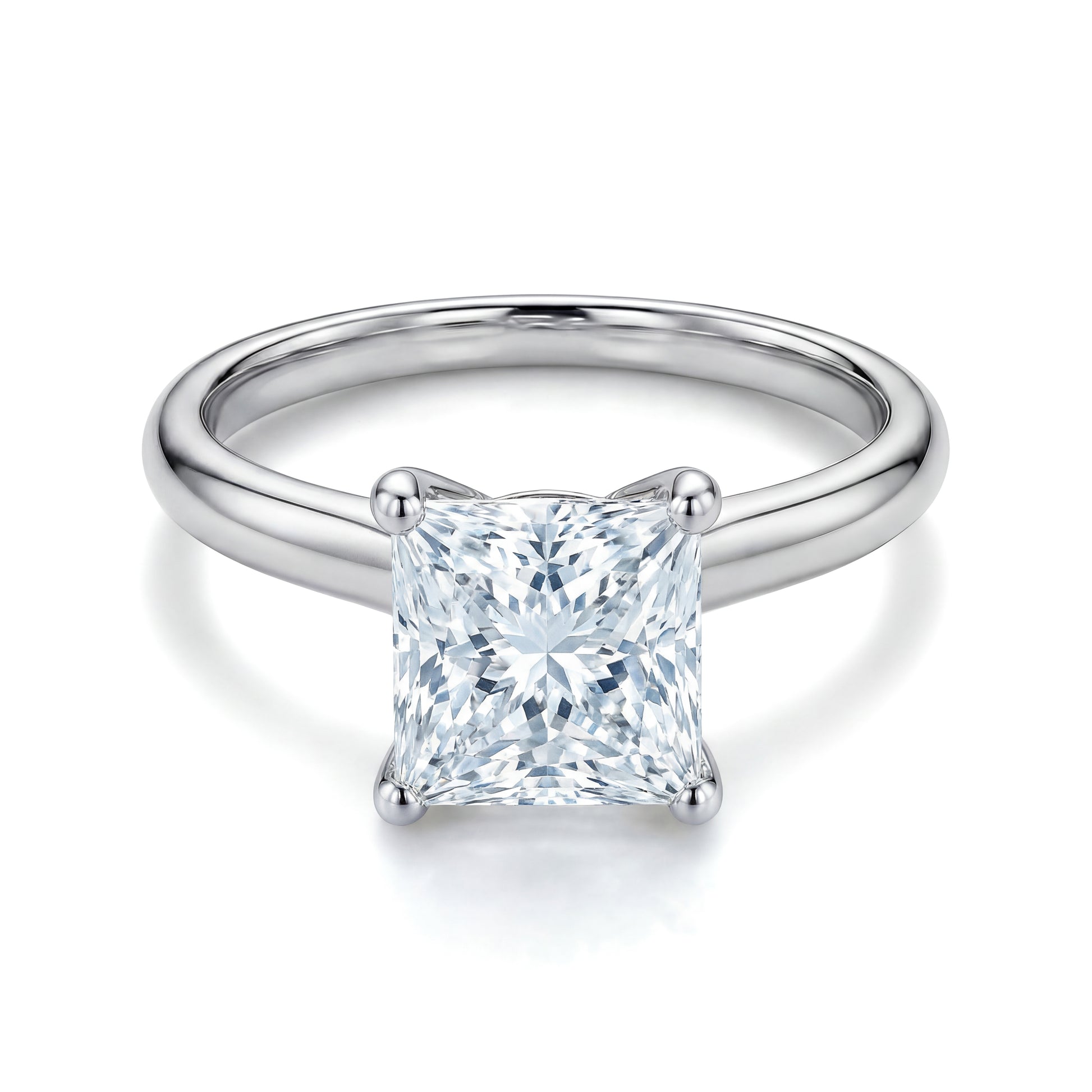 The Raffi&Co.® 18K White Gold Princess Solitaire Diamond Engagement Ring showcases a GIA certified princess cut diamond in a four-prong setting, elegantly presented against a white backdrop.