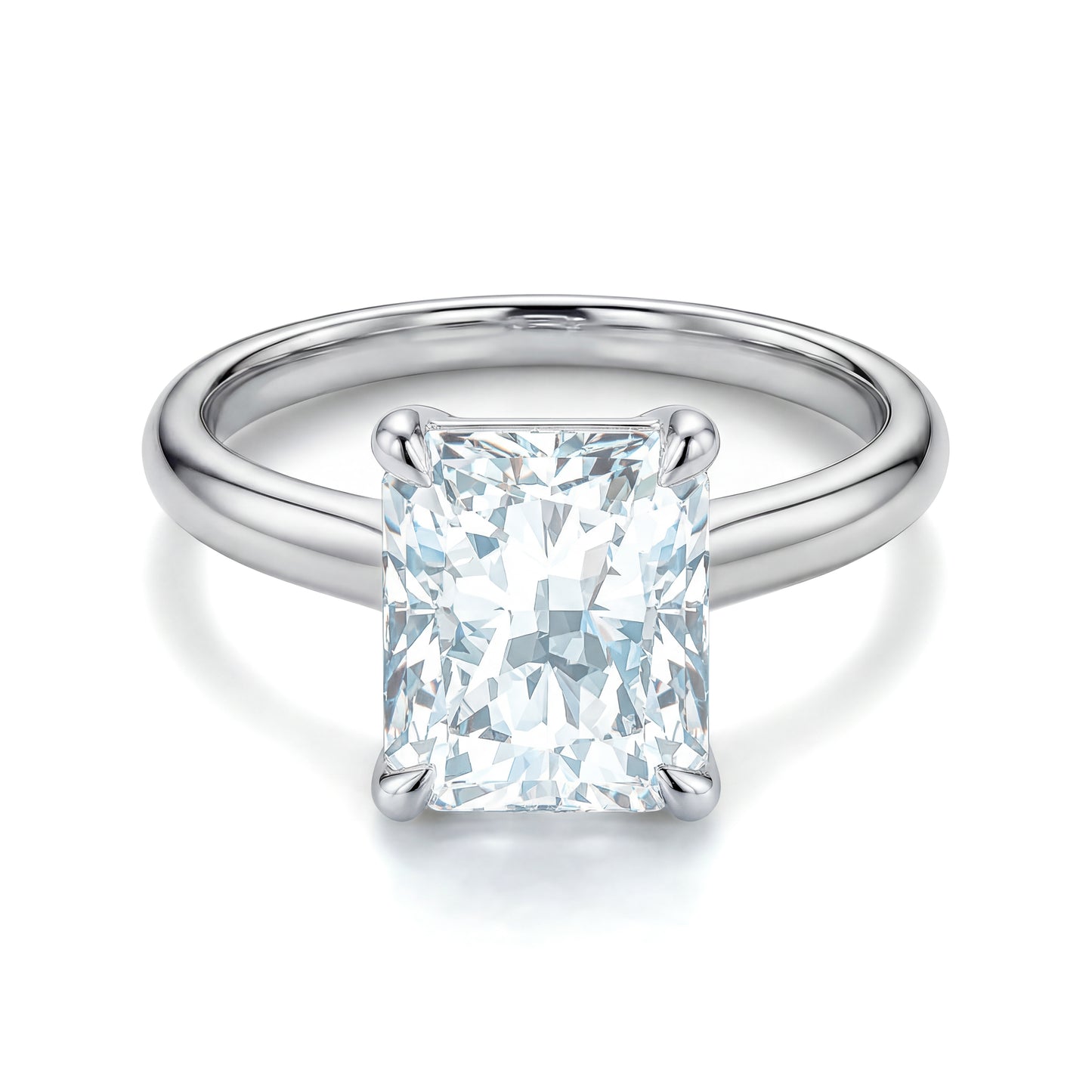 The Raffi&Co.® 14K White Gold Radiant Diamond Solitaire Engagement Ring by Raffi&Co is shown from above, featuring a polished white gold band and dazzling solitaire diamond on a white background.