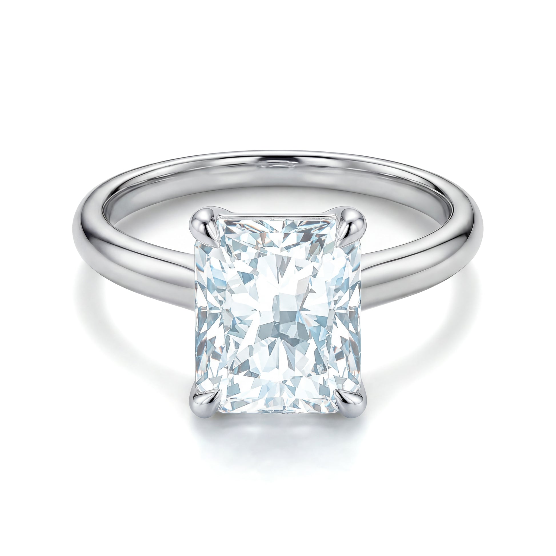 The Raffi&Co.® 14K White Gold Radiant Diamond Solitaire Engagement Ring by Raffi&Co is shown from above, featuring a polished white gold band and dazzling solitaire diamond on a white background.