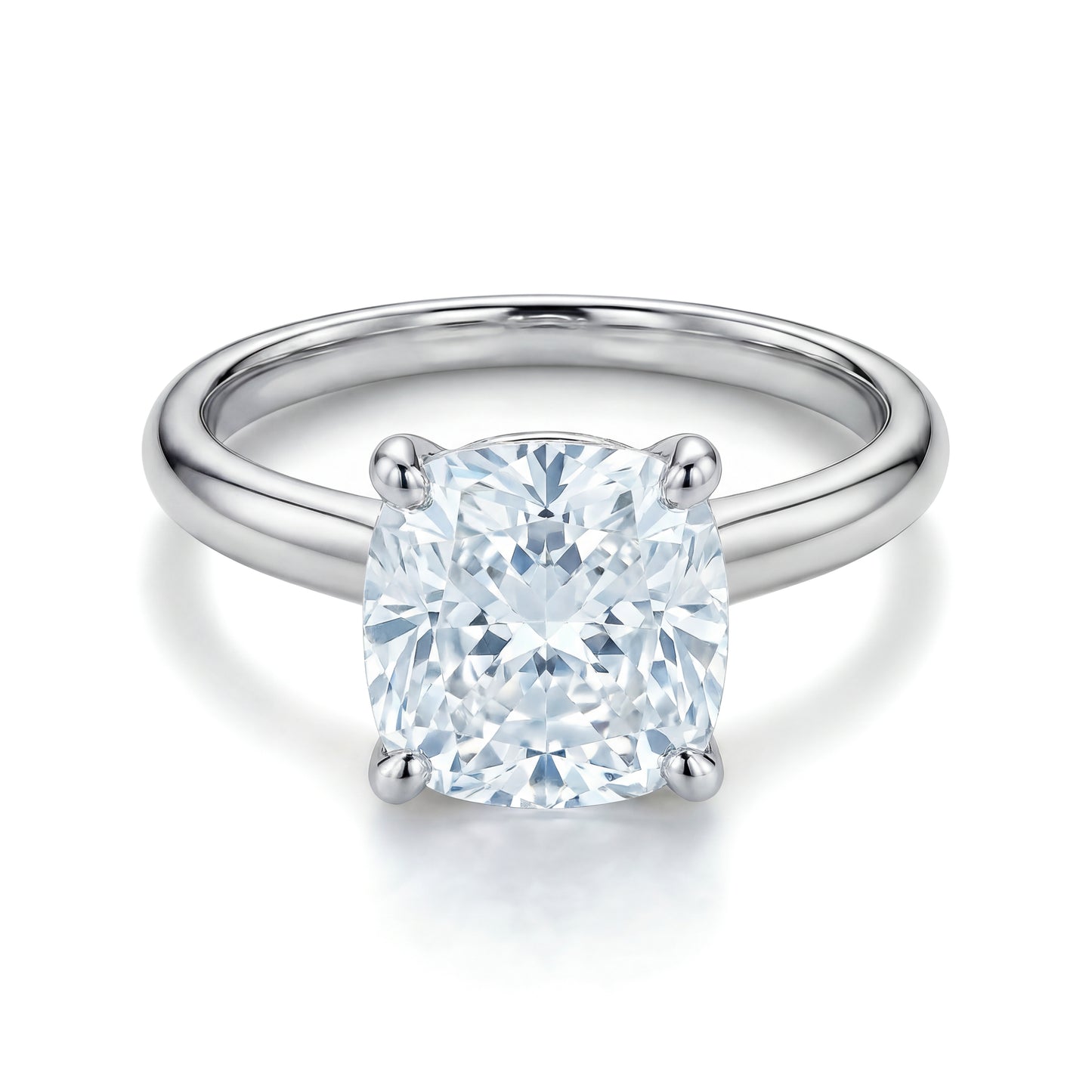 The Raffi&Co.® 14K White Gold Cushion Diamond Solitaire Engagement Ring features a cushion solitaire diamond in a classic four-prong setting.