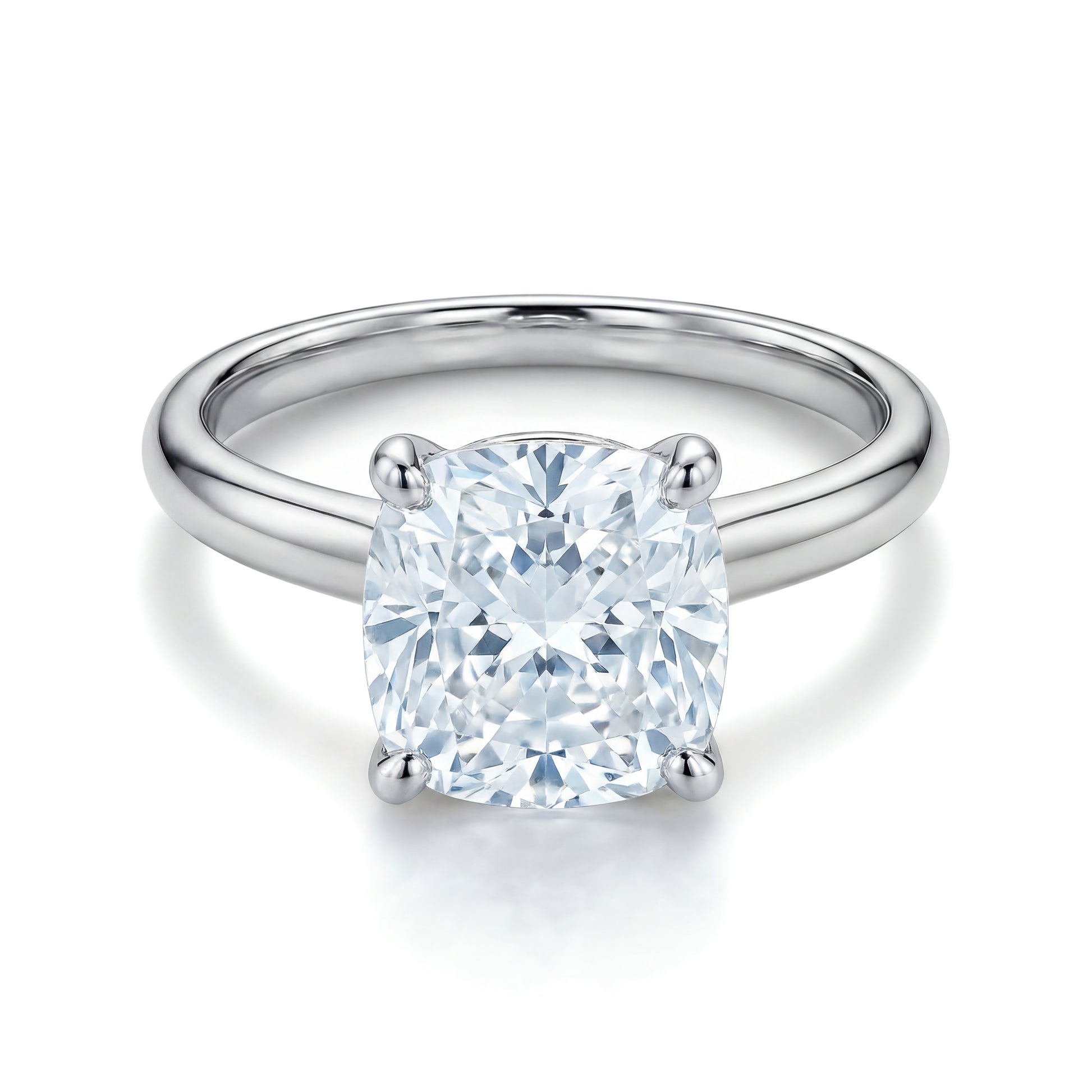 The Raffi&Co.® 14K White Gold Cushion Diamond Solitaire Engagement Ring features a cushion solitaire diamond in a classic four-prong setting.