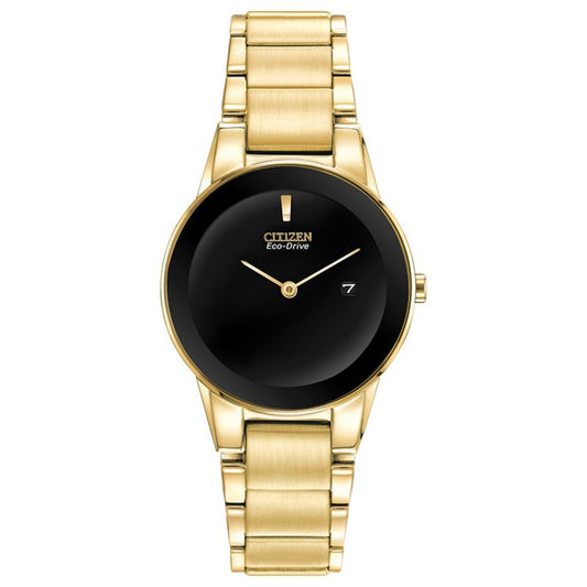 The CITIZEN Axiom Eco-Drive 30mm Watch by CITIZEN is a gold-tone stainless steel timepiece featuring a sleek black dial. It showcases a minimalistic design with gold hour and minute hands, a small date window at the three o'clock position, and an elegant polished gold bracelet complemented by edge-to-edge glass for a modern touch.