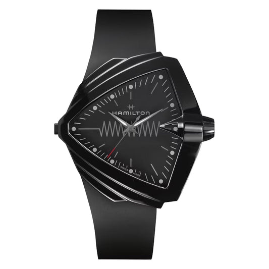 The Hamilton Ventura XXL Bright Quartz is a black triangular wristwatch that features a unique zigzag pattern on the dial, complemented by a black strap and a detailed light-up dial with minimal hour markers.