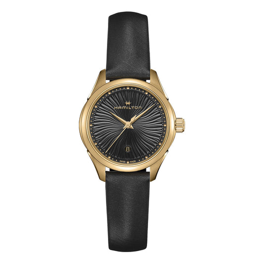 Introducing the Hamilton Jazzmaster Lady Quartz 30mm Watch, a sophisticated timepiece that showcases a gold case and a stunning black velvet dial with radial texture. This watch features elegant gold hands, a convenient date window at the 6 o'clock position, and carries the Hamilton Watch brand name positioned gracefully below the 12 o'clock mark. Its classic allure is further enhanced by a sleek black leather strap.